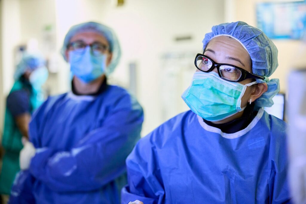 Cardiologist Justin Hartupee, MD, PhD, (in glasses) fellow Kristine Wong, MD, and first year fellow Rohan Bhandari, MD, perform a left heart catheterization on July 8, 2022.
